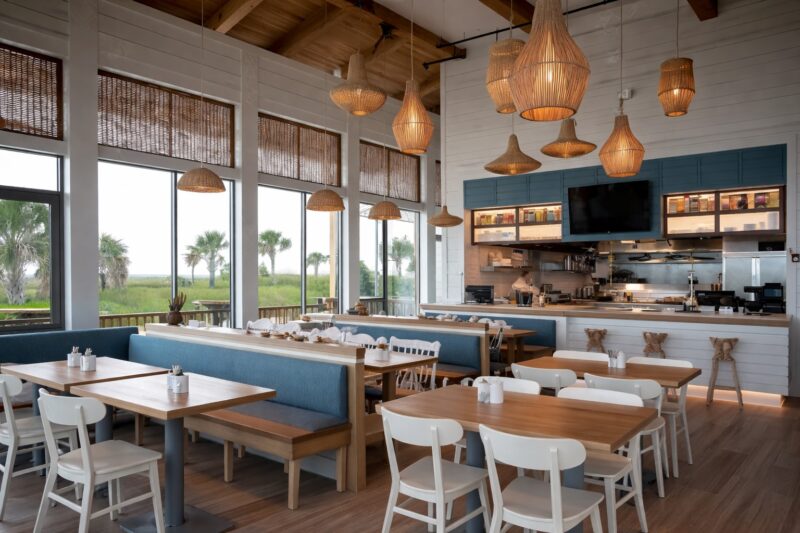 Restaurant interior with coordinated color palette, wooden surfaces, and natural light