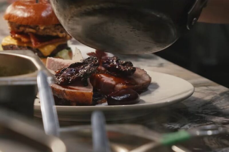 Restaurant staff carefully plating food during service in a calm and focused kitchen environment